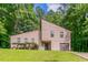Charming home featuring a manicured lawn, tall trees, a garage, and a unique architectural design at 3851 Natalie Way, Ellenwood, GA 30294