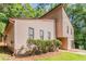 Home featuring a stone foundation, a garage, mature trees, and an inviting facade at 3851 Natalie Way, Ellenwood, GA 30294