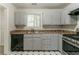 Functional kitchen featuring stainless steel appliances, neutral cabinets, and geometric floor tiles at 3851 Natalie Way, Ellenwood, GA 30294