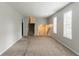 Spacious living room with neutral walls, carpet flooring, and plentiful natural light at 3851 Natalie Way, Ellenwood, GA 30294