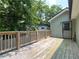 Backyard deck with wooden rails and view of backyard trees at 644 Albert Nw St, Atlanta, GA 30318
