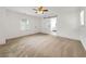 Spacious bedroom with modern fan, neutral carpet, double closets, and ensuite bathroom at 644 Albert Nw St, Atlanta, GA 30318