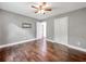 Bedroom featuring hardwood floors, a ceiling fan, gray walls, walk in closet, and gray accent wall at 644 Albert Nw St, Atlanta, GA 30318