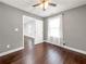 Inviting bedroom with hardwood floors, neutral paint, ceiling fan, and a large window with sheer curtains at 644 Albert Nw St, Atlanta, GA 30318