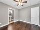 Bedroom featuring hardwood floors, a ceiling fan, gray walls, and view into en suite bathroom at 644 Albert Nw St, Atlanta, GA 30318