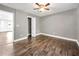 Bedroom featuring hardwood floors, a ceiling fan, gray walls, walk in closet, and an open entry at 644 Albert Nw St, Atlanta, GA 30318