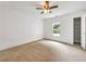 A bright bedroom featuring neutral carpet, a ceiling fan, and a window overlooking a green backyard at 644 Albert Nw St, Atlanta, GA 30318