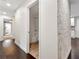 Hallway view of an updated bathroom featuring modern fixtures and a large tiled bathtub at 644 Albert Nw St, Atlanta, GA 30318