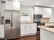 Updated kitchen with white cabinets, stainless steel appliances, granite countertops and modern lighting at 644 Albert Nw St, Atlanta, GA 30318