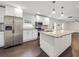 Open kitchen featuring white cabinets, stainless steel appliances, and a large island with granite countertops at 644 Albert Nw St, Atlanta, GA 30318