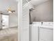 A bright laundry room with a white washer and dryer, complemented by storage shelves above at 644 Albert Nw St, Atlanta, GA 30318