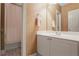 This bathroom offers a white vanity and a shower and tub combo behind a patterned curtain at 1040 Emory Parc Pl, Decatur, GA 30033
