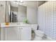Bright bathroom features a white vanity with storage and a shower with a patterned curtain at 1040 Emory Parc Pl, Decatur, GA 30033