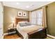 Comfortable bedroom with a wooden bed frame, neutral colors, and natural light at 1040 Emory Parc Pl, Decatur, GA 30033