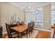 Traditional dining room with chandelier, wood table and floors, plus large window with natural light at 1040 Emory Parc Pl, Decatur, GA 30033