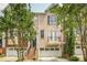 Charming brick townhome featuring a front porch, balcony, and attached two-car garage at 1040 Emory Parc Pl, Decatur, GA 30033