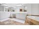Main bathroom featuring dual vanities, large mirrors, and a soaking tub with stone surround at 1040 Emory Parc Pl, Decatur, GA 30033