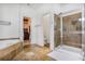 Main bathroom featuring shower with glass door, soaking tub, and walk in closet at 1040 Emory Parc Pl, Decatur, GA 30033