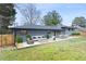 Spacious backyard featuring a patio with a seating area, outdoor dining set, and green lawn at 1120 Taliwa Ne Trl, Marietta, GA 30068