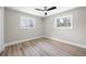 This bedroom is bright and airy, featuring hardwood floors, updated baseboards, and a modern ceiling fan at 1120 Taliwa Ne Trl, Marietta, GA 30068