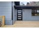 Close up of the front porch showing the modern door with gold hardware and window at 1120 Taliwa Ne Trl, Marietta, GA 30068
