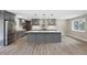 Grey kitchen boasts a large island, stainless steel appliances, and modern pendant lighting at 1120 Taliwa Ne Trl, Marietta, GA 30068