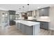Modern grey kitchen with stainless steel refrigerator, ample counter space and access to backyard at 1120 Taliwa Ne Trl, Marietta, GA 30068