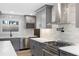 Kitchen features stainless steel appliances, quartz countertops, tile backsplash and a wine rack at 1120 Taliwa Ne Trl, Marietta, GA 30068