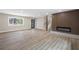 Spacious living room featuring stylish fireplace, staircase, and modern door at 1120 Taliwa Ne Trl, Marietta, GA 30068
