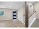 Bright living room with stairs to the basement and a modern front door at 1120 Taliwa Ne Trl, Marietta, GA 30068