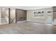 Bright living room featuring modern fireplace, stairs to the basement, and a door to the backyard at 1120 Taliwa Ne Trl, Marietta, GA 30068