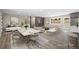 Open concept living and dining area, with large windows, a fireplace, and modern furnishings and decor at 1120 Taliwa Ne Trl, Marietta, GA 30068