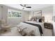 Comfortable main bedroom featuring a large bed, soft lighting, and a window with a view at 1120 Taliwa Ne Trl, Marietta, GA 30068