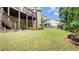A large backyard features an outdoor living space, a patio, and a well maintained lawn at 1980 Marcia Overlook Dr, Cumming, GA 30041