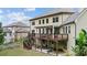 Backyard view of a two-story home, deck with seating, an outdoor dining area and a garden at 1980 Marcia Overlook Dr, Cumming, GA 30041