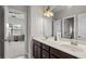 Bathroom featuring double sinks, stylish fixtures, and lots of light, creating a clean and functional space at 1980 Marcia Overlook Dr, Cumming, GA 30041