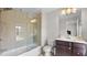 Bathroom showcasing a shower with glass doors, tile surround, and vanity with storage at 1980 Marcia Overlook Dr, Cumming, GA 30041