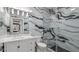 Modern bathroom featuring a glass shower with black and white marble tiling at 1980 Marcia Overlook Dr, Cumming, GA 30041