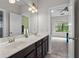 Bathroom featuring double sinks and a view to the bedroom, designed for style and functionality at 1980 Marcia Overlook Dr, Cumming, GA 30041