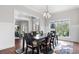 Bright dining room featuring a dark wood table, decorative rug, and views into the workout room at 1980 Marcia Overlook Dr, Cumming, GA 30041