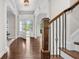 Elegant foyer with hardwood floors, staircase, and a view to the entry at 1980 Marcia Overlook Dr, Cumming, GA 30041