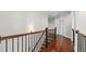 Upstairs hallway featuring hardwood floors and decorative railing, and a view of surrounding rooms at 1980 Marcia Overlook Dr, Cumming, GA 30041