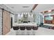 Modern kitchen with stone backsplash, kitchen island, stainless appliances, and a barn door at 1980 Marcia Overlook Dr, Cumming, GA 30041