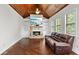 Inviting living room with a stone fireplace, wood ceiling, and lots of natural light at 1980 Marcia Overlook Dr, Cumming, GA 30041
