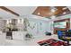 Bright living room with fireplace, a TV, decorative plants, and a modern kitchen at 1980 Marcia Overlook Dr, Cumming, GA 30041