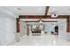 Spacious living room with a stone accent wall, an island, wooden beams, and a projector at 1980 Marcia Overlook Dr, Cumming, GA 30041