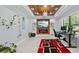 Open living room with a wooden ceiling, a built-in fireplace, a TV, and large windows at 1980 Marcia Overlook Dr, Cumming, GA 30041