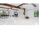 Spacious living room with a kitchen, wooden beams, a projector, and a TV with fireplace at 1980 Marcia Overlook Dr, Cumming, GA 30041