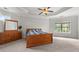 Bright main bedroom featuring neutral walls, carpet, a ceiling fan and a large window providing ample natural light at 1980 Marcia Overlook Dr, Cumming, GA 30041