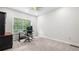 Bright office featuring neutral walls, carpet, a ceiling fan and a large window providing ample natural light at 1980 Marcia Overlook Dr, Cumming, GA 30041